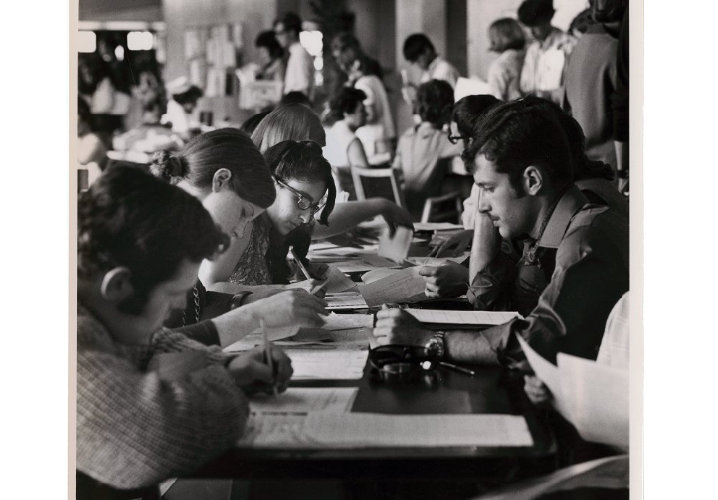 Students filling out forms in the Science Wing, possibly for course enrollment, dated to 1969.