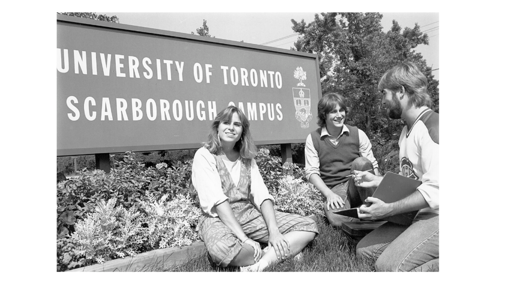 Students seated by the UTSC sign