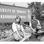 Students seated by the UTSC sign